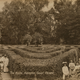 A postcard showing visitors posing in the Maze at Hampton Court Palace